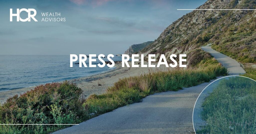 Scenic coastal road with 'Press Release' text overlay.