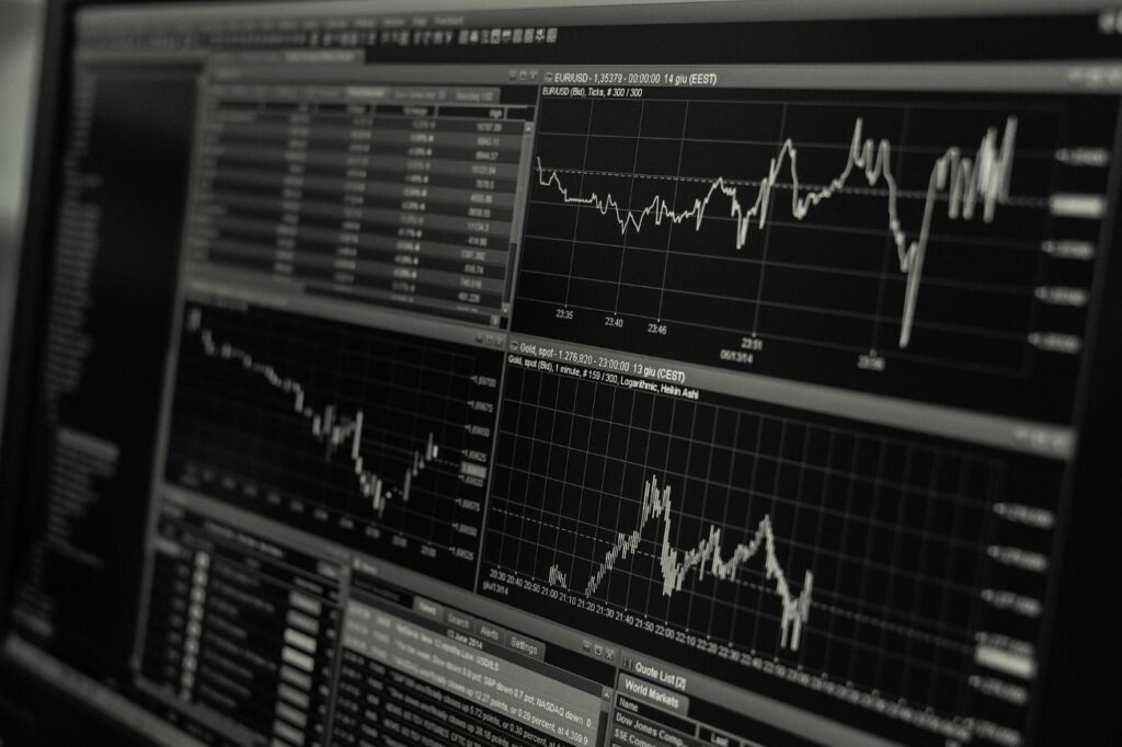 Multiple financial charts showing stock market trends with fluctuating graphs.