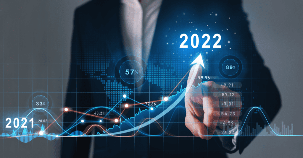 Businessman pointing at a rising financial graph with 2022 highlighted.
