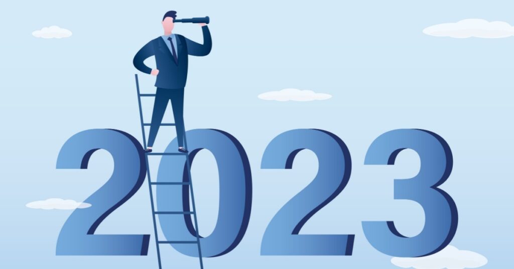 Businessman on ladder looking ahead from 2023 numbers.
