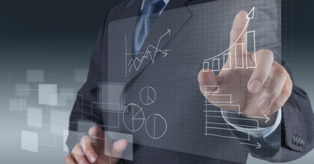 Businessman touching transparent screen with growth charts